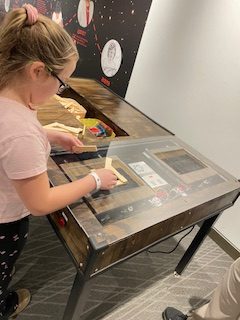 Monroe Science Center visitor works at earthquake simulation shaker table